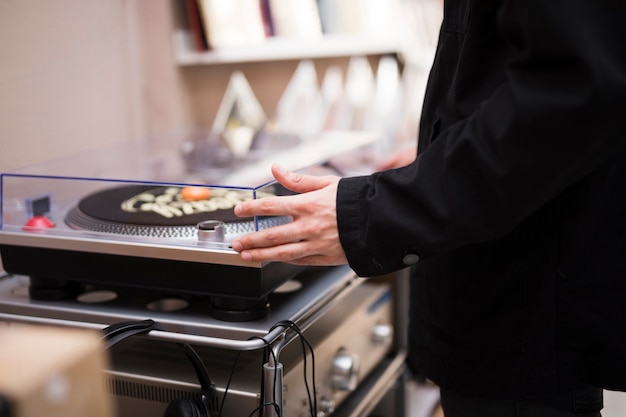 Close-up young man looking at turntable