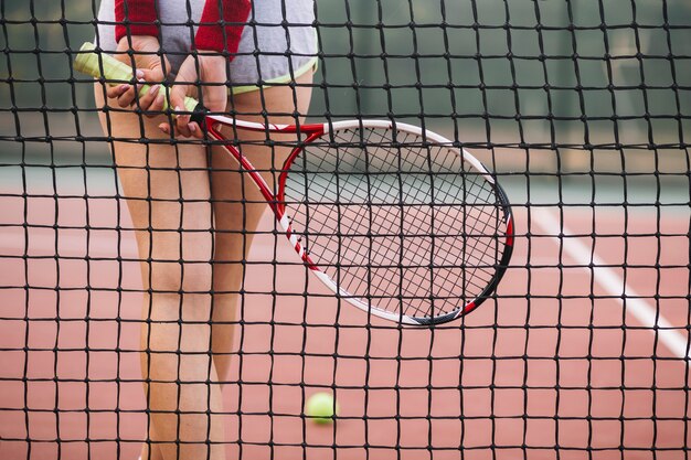 Close-up young player of tennis on field