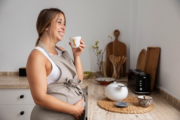 Close up on young pregnant woman cooking