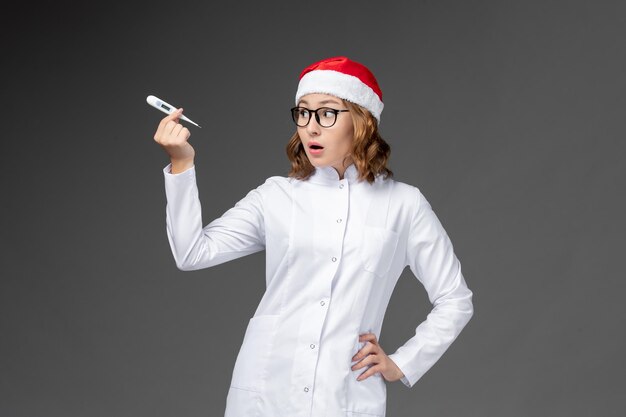 Close up on young pretty woman wearing Christmas hat isolated