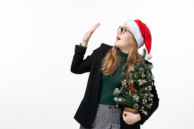 Close up on young pretty woman wearing Christmas hat isolated