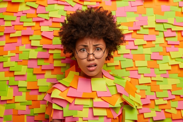 Close up on young student surrounded by sticky notes