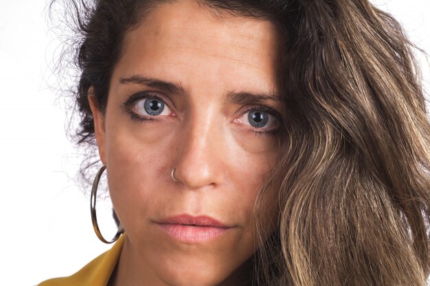 Close-up of young woman looking at camera.