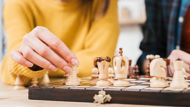 Free Photo close-up of young woman playing the chess board game