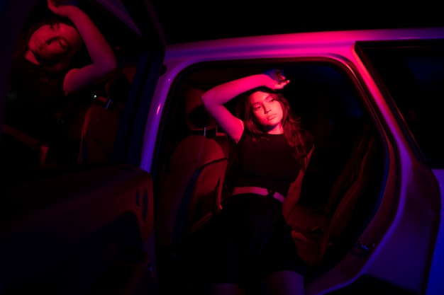 Close up on young woman posing in dramatic light