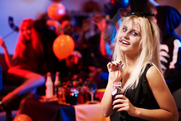 Close up on young woman with a bloody drink