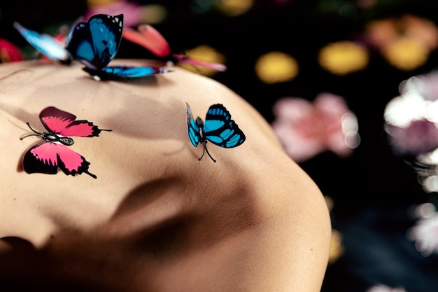 Free photo close-up young woman with butterflies on top