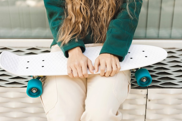 Close-up young woman with skateboard