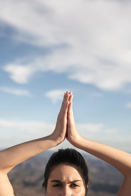 Close-up young woman in yoga pose