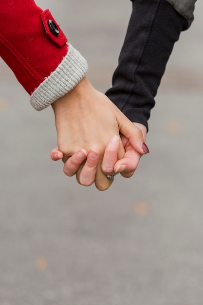 Free Photo close-up young women hands holding hands