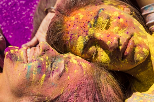 Close-up of young women's face covered with holi color