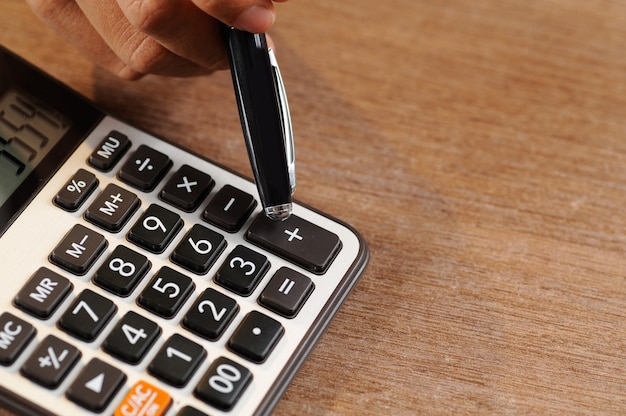 Closeup of accountant counting on calculator