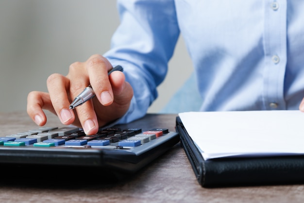 Closeup of accountant using calculator