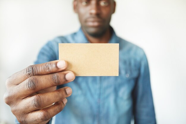 Closeup of African man’s hands holding business card