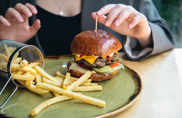 Closeup appetizing burger and french fries in a cafe