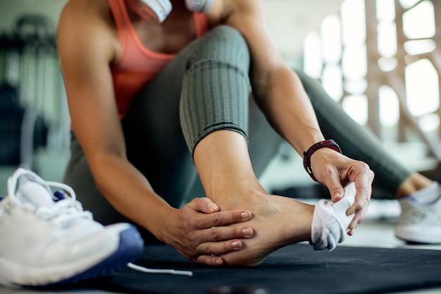 Free Photo closeup of athletic woman injured her foot during workout at the gym