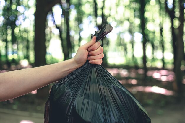 Closeup a bag of garbage on a blurred background of the forest