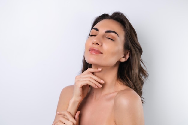 Closeup beauty portrait of a topless woman with perfect skin and natural makeup