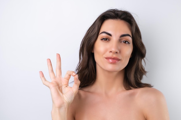 Closeup beauty portrait of a topless woman with perfect skin and natural makeup