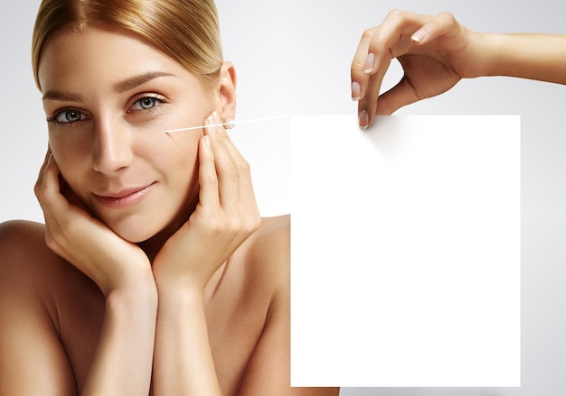 Free Photo closeup of a beauty woman with ideal skin looking at camera on a grey background