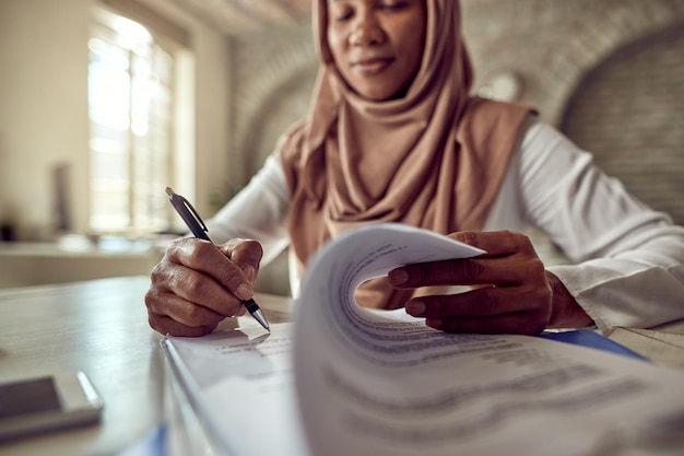 Free photo closeup of black islamic businesswoman signing a contract in the office