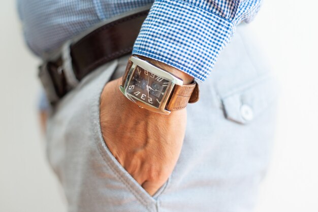 Closeup of business man keeping hand in trousers pocket