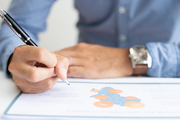 Closeup of business man studying map chart