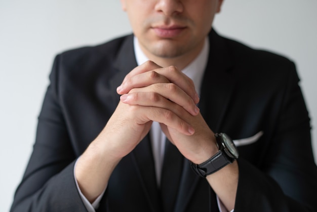 Closeup of business man with clasped hands