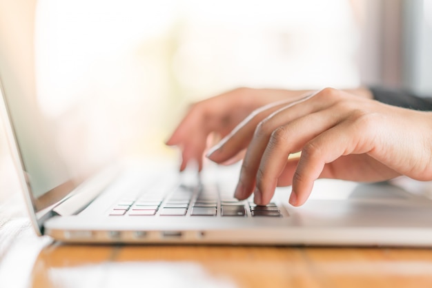 Free photo closeup of business woman hand typing on laptop keyboard .