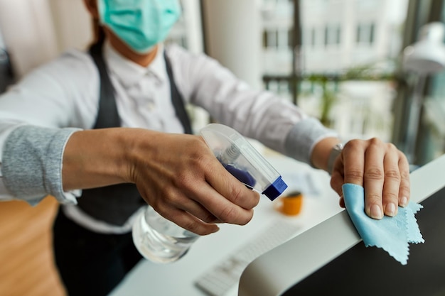 Free photo closeup of businesswoman cleaning her computer while working in the office