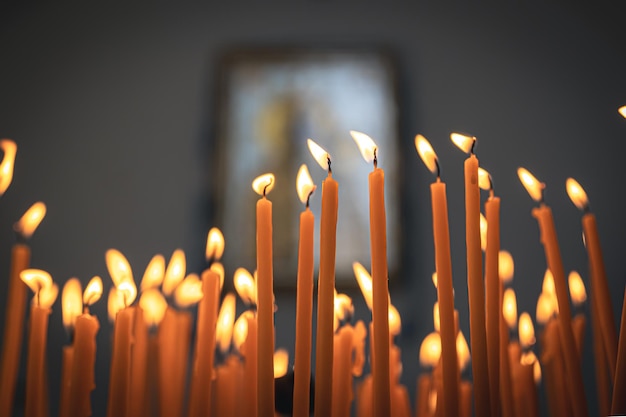 Closeup candles in the temple on a blurred background