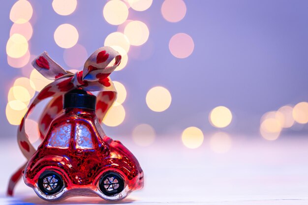 Closeup carshaped Christmas toy on a blurred background with bokeh