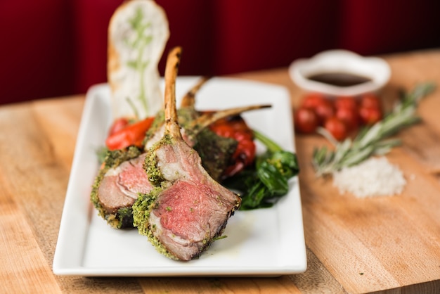 Closeup of cooked beef with spices and fried green and red peppers with a blurred background