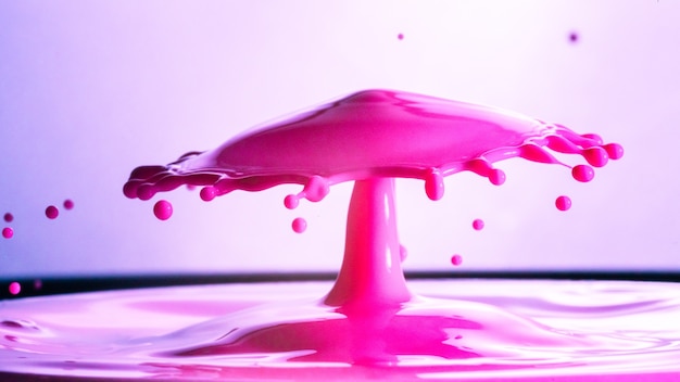 Closeup of a cool pink water splash against a blurred background - great for wallpapers