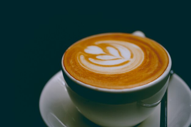 Closeup of a cup of delicious latte on a saucer