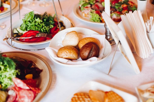 Closeup of delicious meat balls and fish rolls catered on rectangular balls with sticks for snacks Variety of food on birthday corporate party or wedding celebration