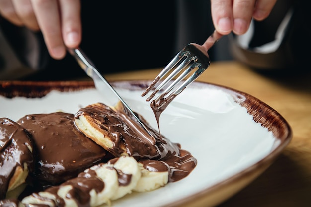 Free photo closeup delicious pancakes with chocolate and banana for breakfast