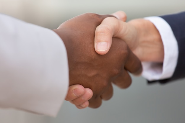 Free photo closeup of diverse business colleagues handshake