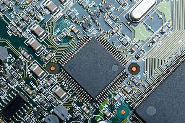 Closeup of electronic circuit board with CPU microchip electronic components background