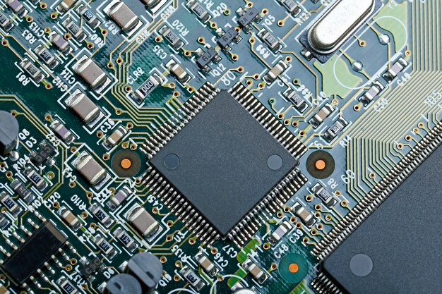 Closeup of electronic circuit board with CPU microchip electronic components background