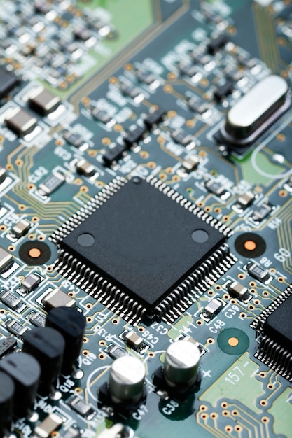 Closeup of electronic circuit board with CPU microchip electronic components background