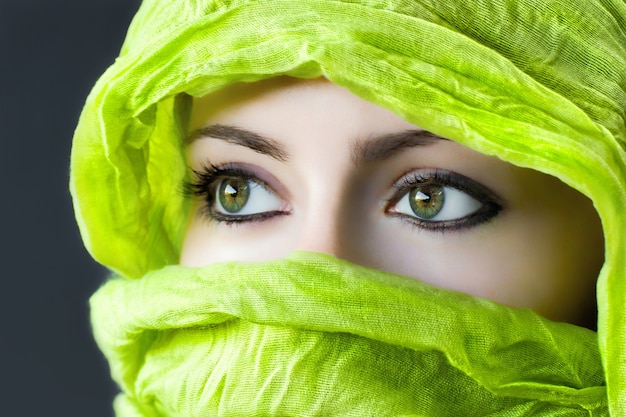 Free Photo closeup of the eyes of a woman with a green hijab under the lights