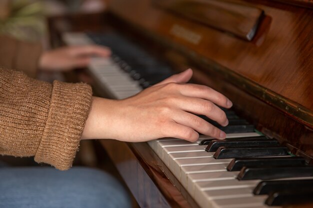 Closeup of female hands playing the piano