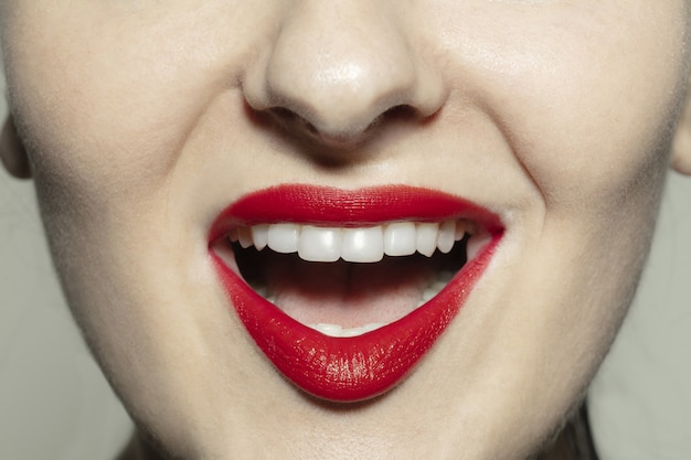 Closeup female mouth with bright red gloss lips