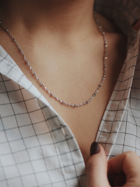 Free photo closeup of a female wearing a beautiful silver necklace