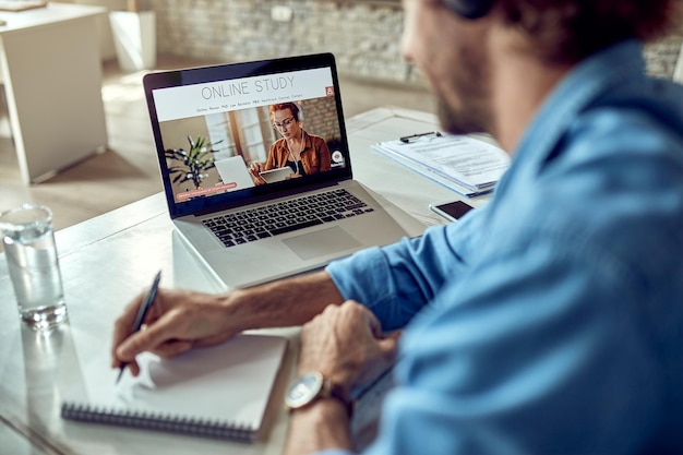 Closeup of freelancer learning online while using laptop in the office