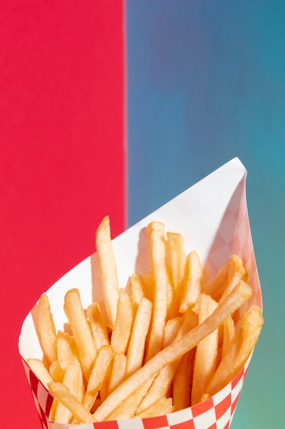 Closeup fries potatoes with red and blue background