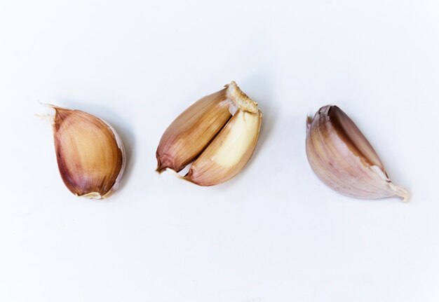 Closeup of garlic cloves on white background