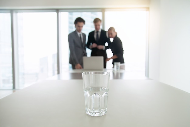 Free photo closeup of a glass of water on office desk