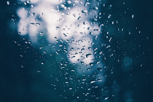 Closeup of a glass with water drips on it after a rain